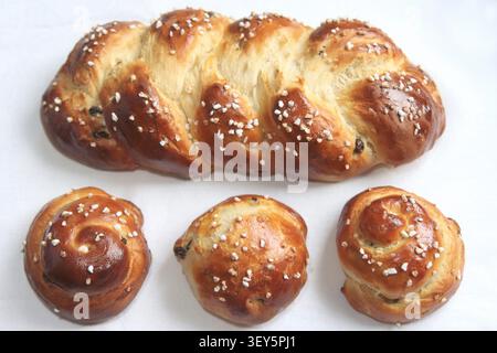 freshly baked hefezopf loaf with raisins and three Schnecken Stock Photo