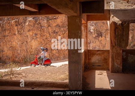 Couple on Vintage Red Scooter at Rodalquilar Gold Mine Ruins Cabo de Gata Park Almeria, Spain Stock Photo