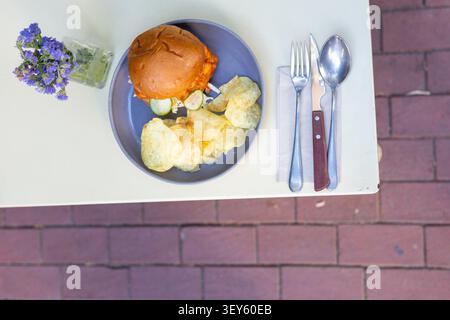 Cheeseburger and Chips Restaurant Presentation Close-Up Stock Photo