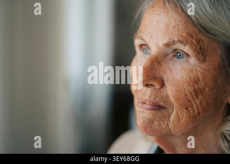 Close-up of thoughtful elderly woman looking away at nursing home Stock Photo