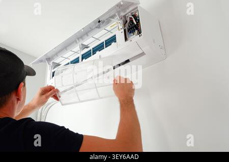 Air conditioner service. The technician checks the operation of the air conditioner. Filter replacement. Cleaning. Stock Photo