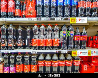 Supermarket shelves stocked with 1.5 litre plastic bottles of Coca-Cola, Pepsi, U Cola - Super U supermarket, La Roche Posay, Vienne (86), France. Stock Photo