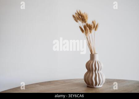 Scandinavian Style Vase with Dried Wheat in Minimalist Beige Interior Stock Photo
