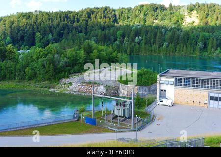 Aerial view of a power substation nestled within a dense forest during ...