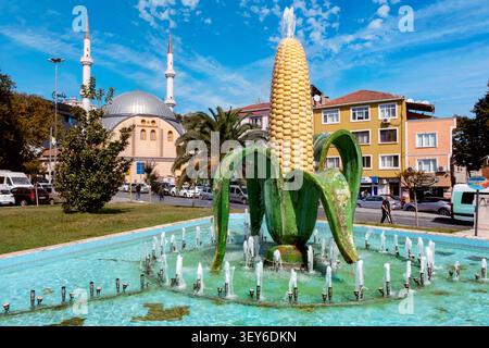 Corn on the cob fountain / statue by Orhan Albaş and Alibeyköy Central Mosque, Eyüpsultan District, Istanbul, Turkey, Türkiye, Europe Stock Photo