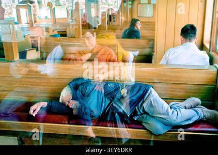 Elderly man sleeping on a Sehir Hatlari passenger ferry, Istanbul, Turkey, Türkiye, Europe, Asia Stock Photo