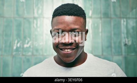Smiling Young Man Portrait With Clean Fresh Look and Tiled Bathroom Background Stock Photo