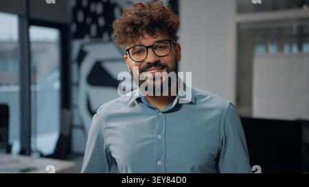 Close up portrait Arabian business man smiling dental with healthy teeth looking at camera posing in office ethnic happy satisfied adult businessman Stock Photo