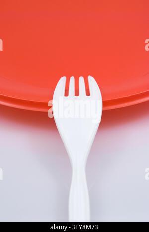 disposable fork and red dish Stock Photo
