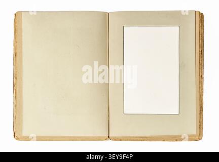 Antique open book with a blank photo frame cutout on the right page isolated on white background. Stock Photo