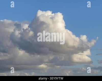 Large white cloud Cumulus cluster cloud against blue sky, Germany Stock Photo
