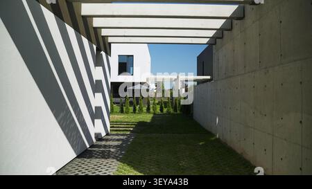 Modern concrete and minimalist architecture featuring strong geometric shadows on a residential villa backyard Stock Photo