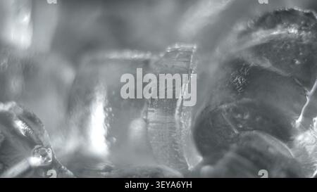 Ice cubes forming abstract frosty texture with frozen water crystals and cold winter background Stock Photo