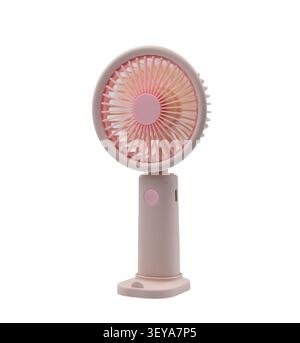 Portable pink handheld electric fan on a white background for cooling off on hot summer days Stock Photo