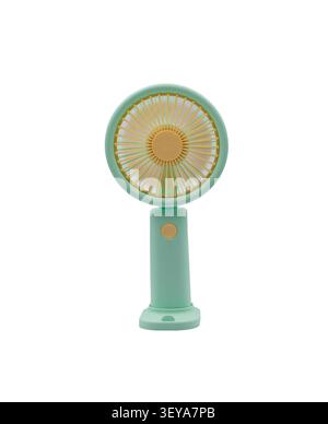 Portable green handheld electric fan on a white background for cooling on hot summer days Stock Photo