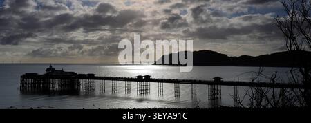 Dramatic clouds over Llandudno Pier and The Little Orme, Llandudno town, Conwy, North Wales, Britain. Stock Photo