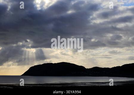 Dramatic clouds over Llandudno Pier and The Little Orme, Llandudno town, Conwy, North Wales, Britain. Stock Photo