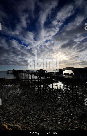 Dramatic clouds over Llandudno Pier and The Little Orme, Llandudno town, Conwy, North Wales, Britain. Stock Photo