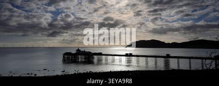 Dramatic clouds over Llandudno Pier and The Little Orme, Llandudno town, Conwy, North Wales, Britain. Stock Photo