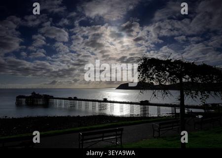 Dramatic clouds over Llandudno Pier and The Little Orme, Llandudno town, Conwy, North Wales, Britain. Stock Photo