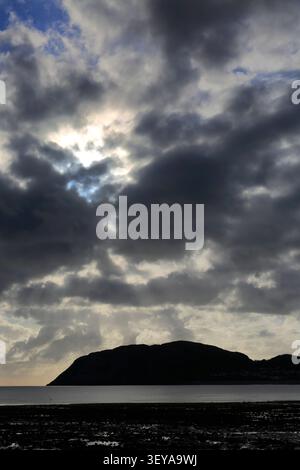 Dramatic clouds over Llandudno Pier and The Little Orme, Llandudno town, Conwy, North Wales, Britain. Stock Photo