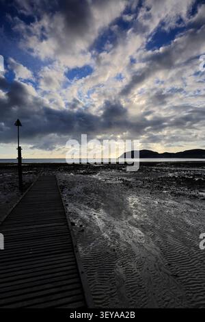 Dramatic clouds over Llandudno Pier and The Little Orme, Llandudno town, Conwy, North Wales, Britain. Stock Photo