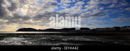 Dramatic clouds over Llandudno Pier and The Little Orme, Llandudno town, Conwy, North Wales, Britain. Stock Photo