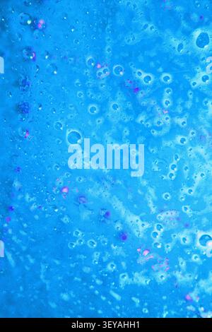 Close-up view of water droplets glistening on a fresh and crisp surface, showcasing the natural beauty of blue hues. Stock Photo