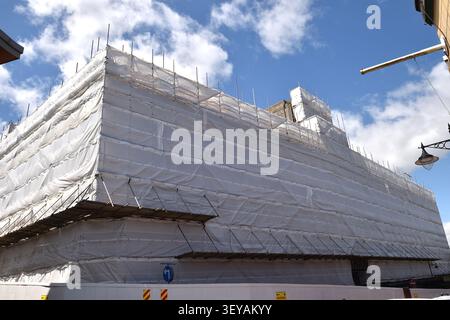 Large Construction Site Scaffold Covered with Polythene Stock Photo