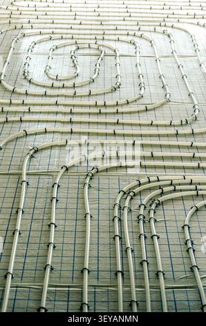 Work in progress on a building site with pipes for floor heating laid out on an apartment floor Stock Photo