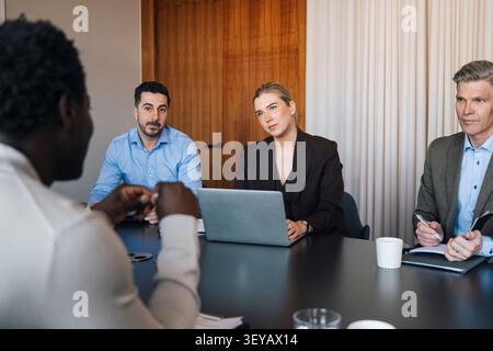Group of corporate professionals having discussion in office meeting room Stock Photo