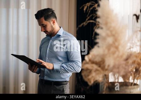 Businessman reviewing documents while working at office Stock Photo