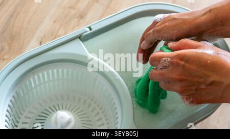 Close up of female hand using wireless computer mouse while working on laptop Stock Photo
