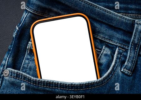 Blank smartphone screen in blue jeans pocket with orange case Stock Photo