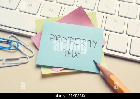 Property tax. Stationery and computer keyboard on table, closeup Stock Photo