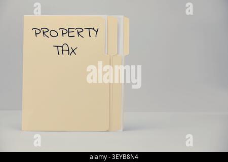 Property tax. Folders with documents on grey background, top view. Space for text Stock Photo