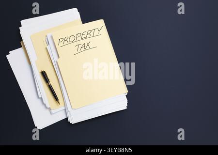Property tax. Folders with papers on dark background, top view. Space for text Stock Photo