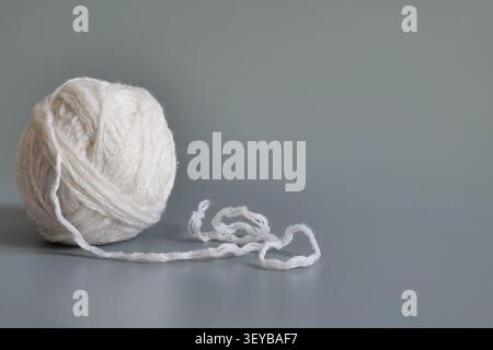 White Ball of Knitting Yarn on Gray Background Stock Photo