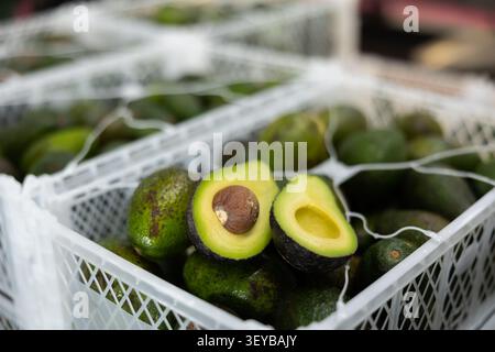 Fresh ripe sliced avocado on boxes close up Stock Photo