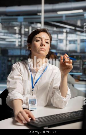 Data center technician deploys data backup solutions, managing server storage and supporting reliable recovery. Stock Photo