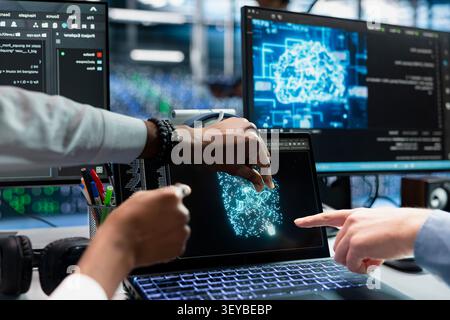 Data center programmers use a digital device in a data center to support automation monitoring and reliable server workflows. Stock Photo