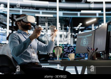 Data center engineer uses a VR headset to inspect AI neural networks and server systems in a high-tech facility. Stock Photo