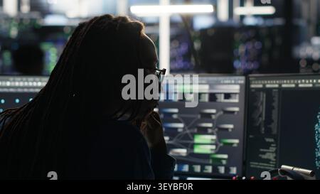 Computer scientist reviews node tree software to analyze datasets and improve server infrastructure performance. Stock Photo