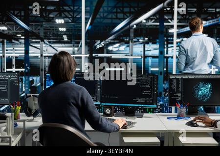 System administrator inspects server infrastructure, performs maintenance checks and reviews equipment diagnostics. Stock Photo