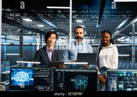 Technicians resolve server connection problems in a server room with artificial intelligence support. Stock Photo