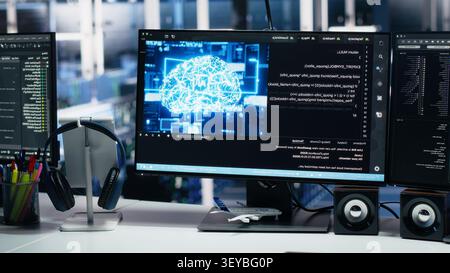 IT specialist reviews neural network visualization on computer screens in a server room during software debugging work. Stock Photo
