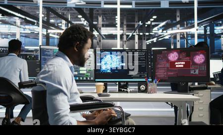Overworked man in wheelchair upset by error warning popup while reviewing data center AI analytics metrics. Stock Photo