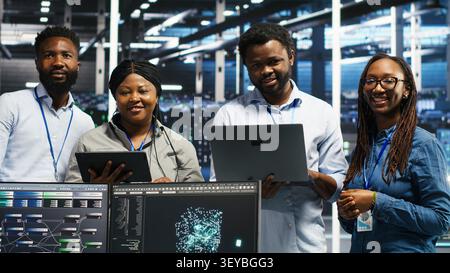 Engineers use a computer workstation in a server hub to categorize unstructured data with node tree systems. Stock Photo