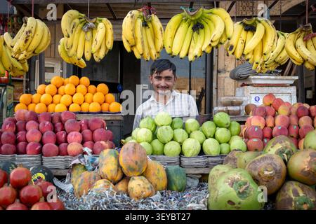 Man selling fruit at Manak Chowk market in Jaisalmer, India Stock Photo