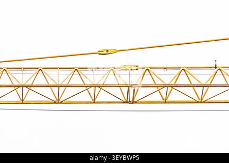 Yellow crane arm with hook mechanism, featuring structural components, interconnected metal beams, and trusses against white background, highlighting Stock Photo